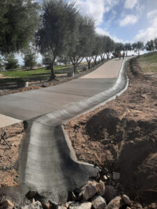 Radius brow ditch that goes along the driveway to preven the concrete from washing out