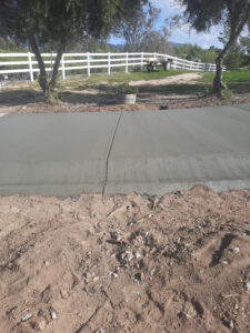 Radius brow ditch that goes along the driveway to preven the concrete from washing out