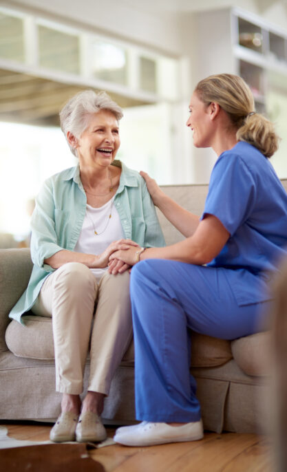 Shot of a caregiver sitting with a senior patient in a nursing home