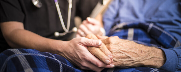 A stock photo of a Hospice Nurse visiting an Elderly male patient who is receiving hospice/palliative care.